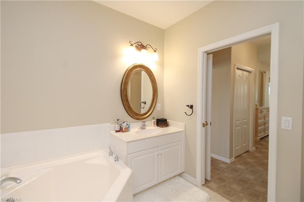 Bathroom with vanity and a tub