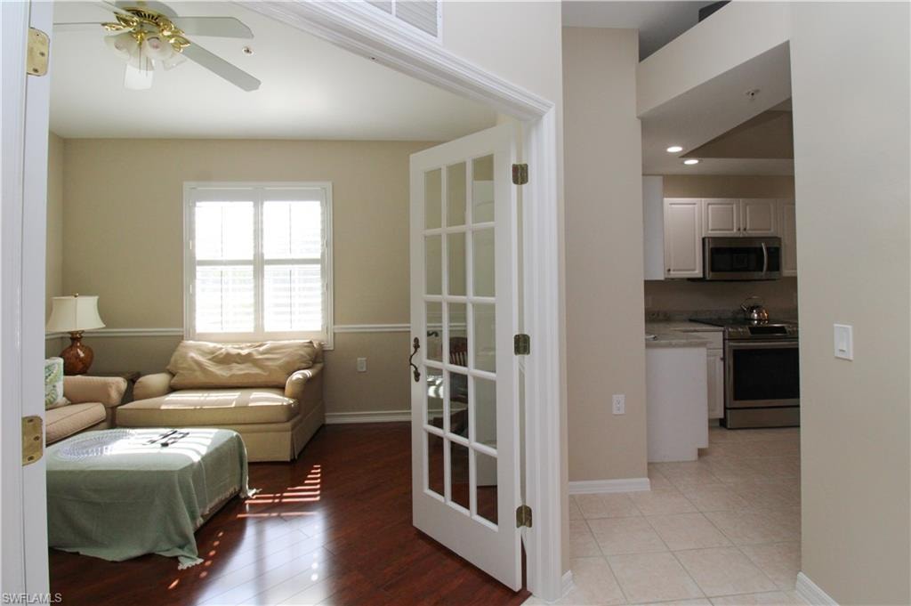 Living room featuring ceiling fan and light hardwood / wood-style floors