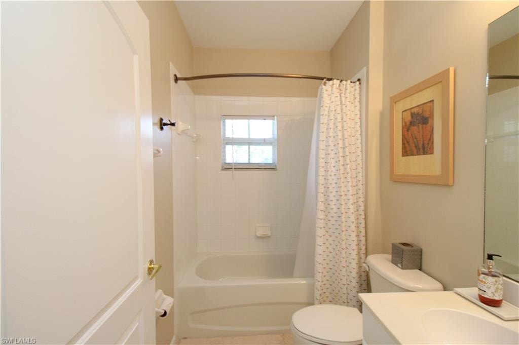Full bathroom with shower / tub combo, vanity, and toilet
