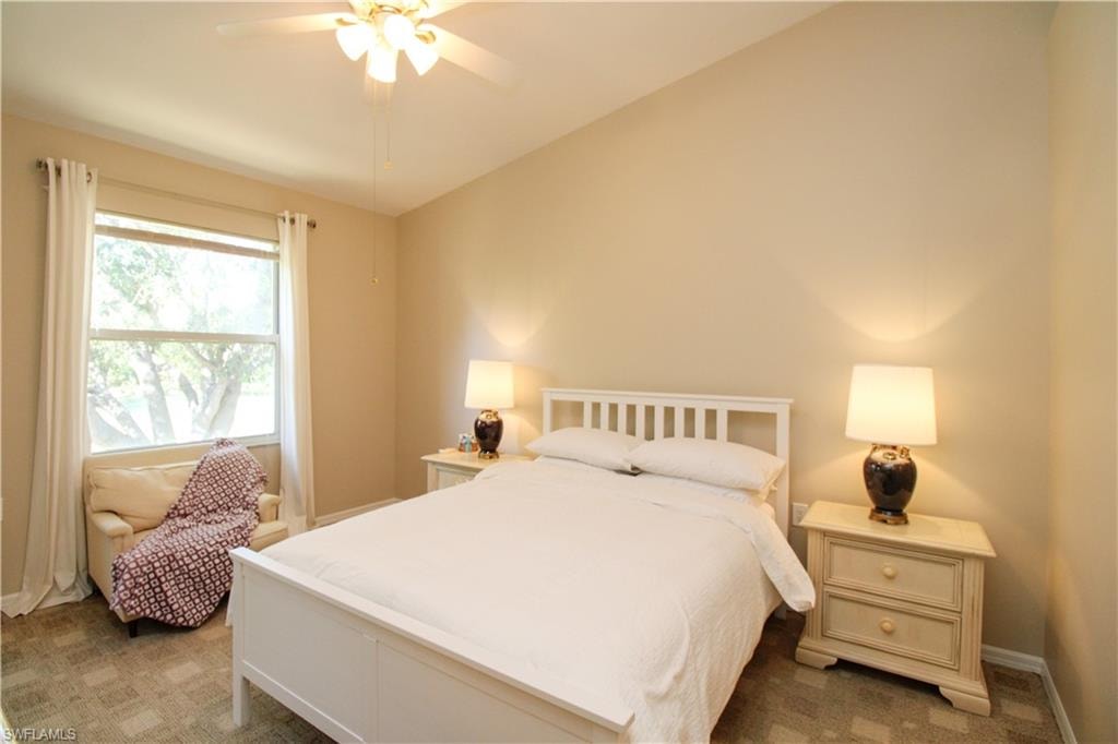 Bedroom featuring ceiling fan and carpet