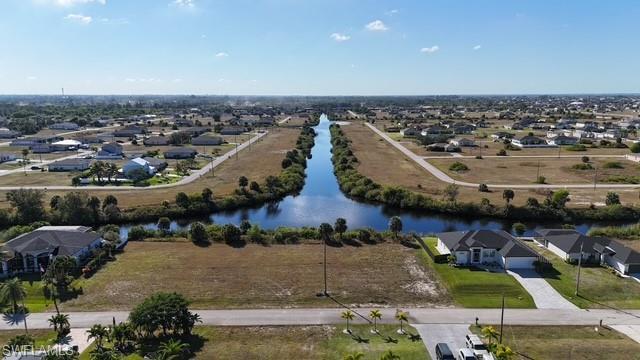 Aerial perspective of suburban area featuring a large body of water
