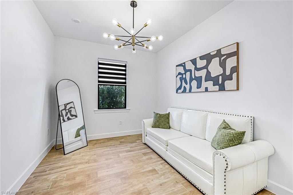 Living area with light wood-style flooring and a chandelier