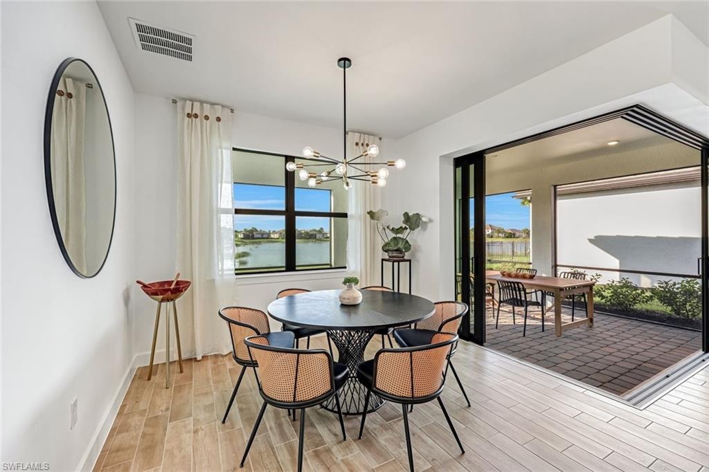 Dining area with wood finish floors and a chandelier