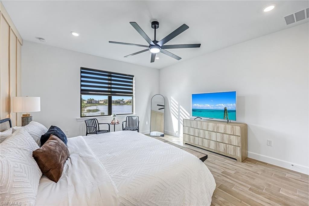 Bedroom featuring wood finish floors, a ceiling fan, and recessed lighting