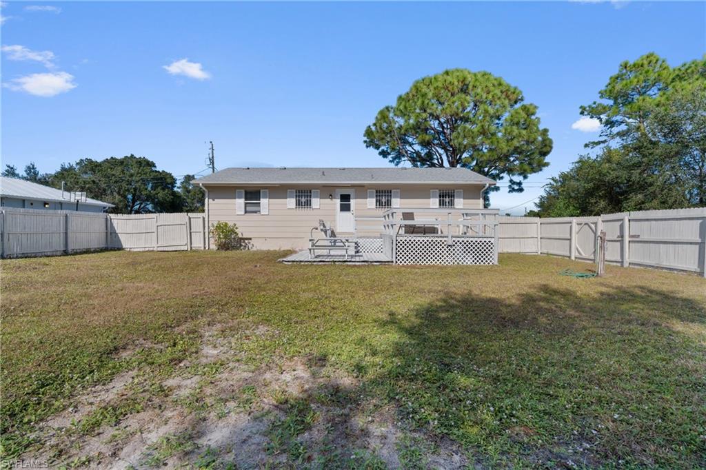 Back of house featuring a wooden deck and a fenced backyard