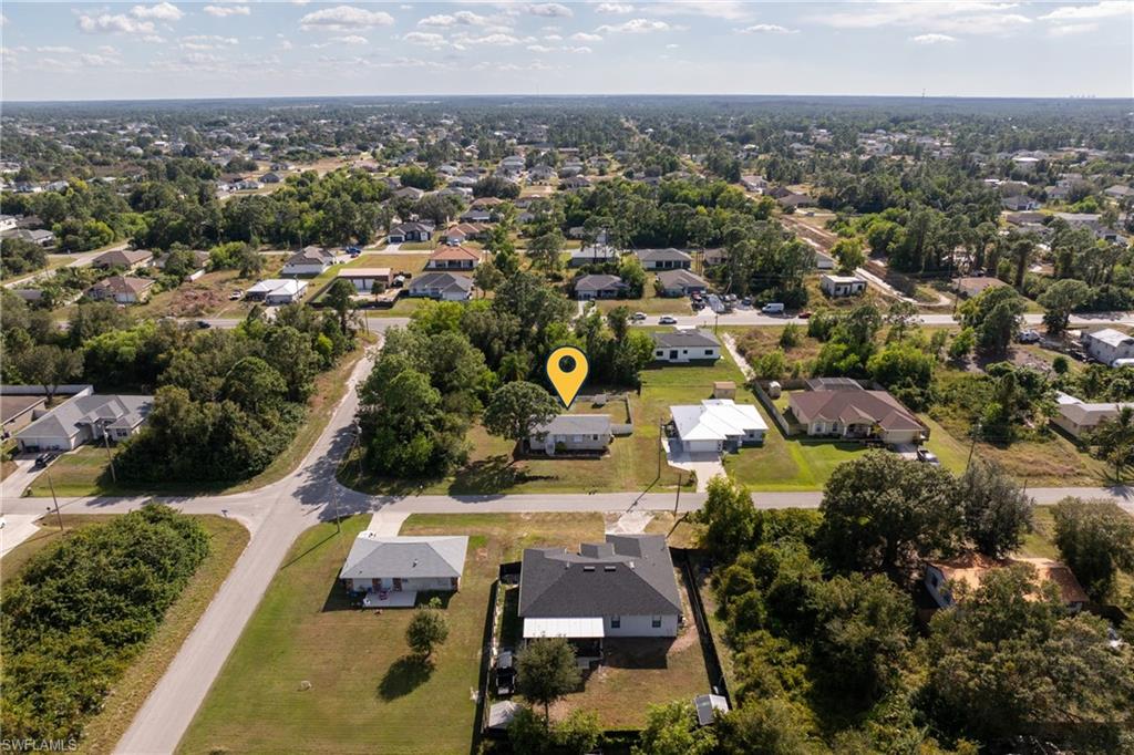 Aerial view of property's location featuring nearby suburban area