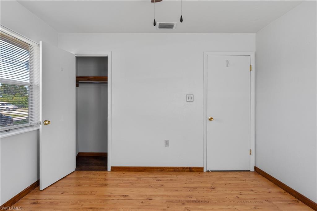 Unfurnished bedroom with light wood finished floors, a closet, and ceiling fan