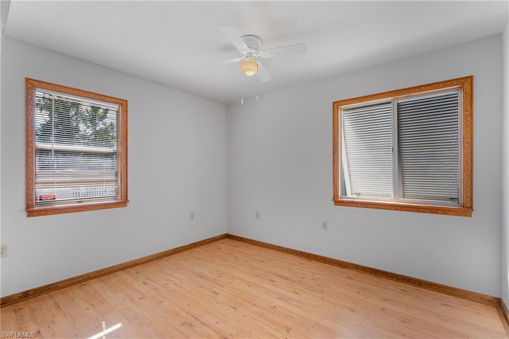 Spare room with light wood-type flooring and a ceiling fan