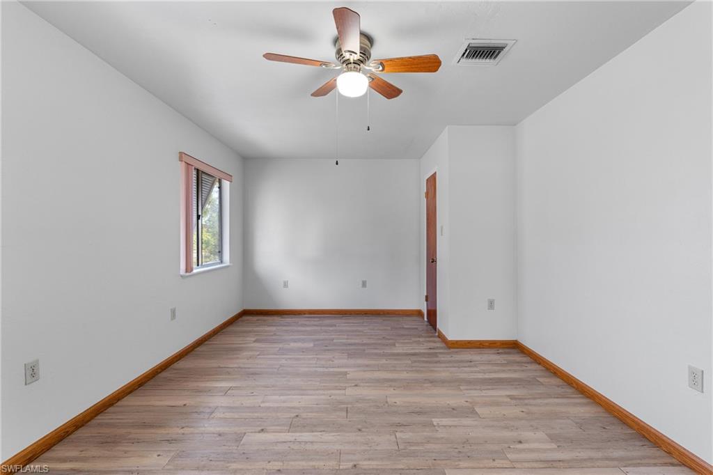 Unfurnished room with light wood-type flooring and ceiling fan