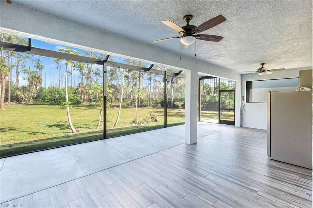 Unfurnished sunroom featuring a ceiling fan