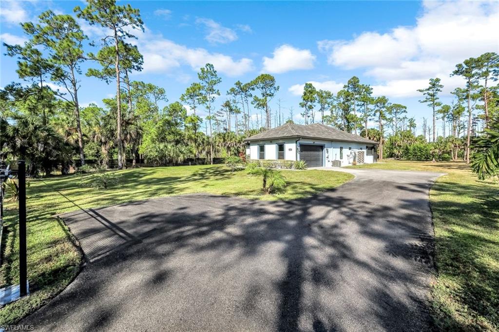 View of front of house with a front lawn and driveway