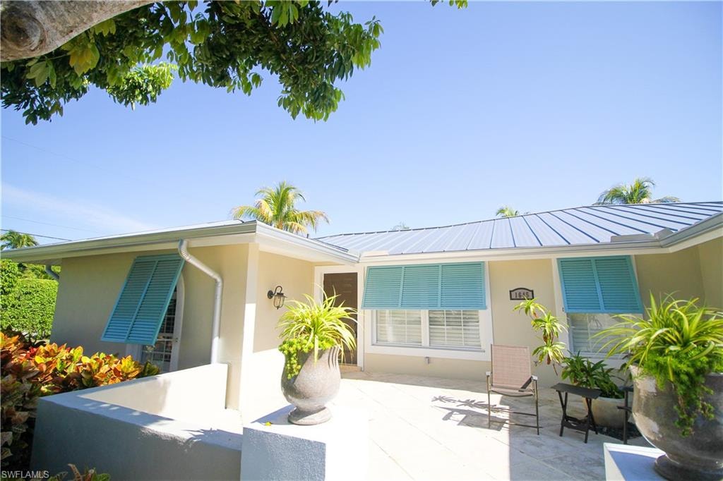 Back of property featuring stucco siding