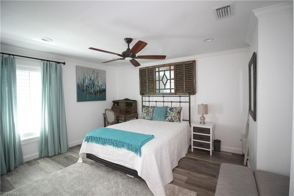 Bedroom featuring wood finished floors, ornamental molding, ceiling fan, and recessed lighting
