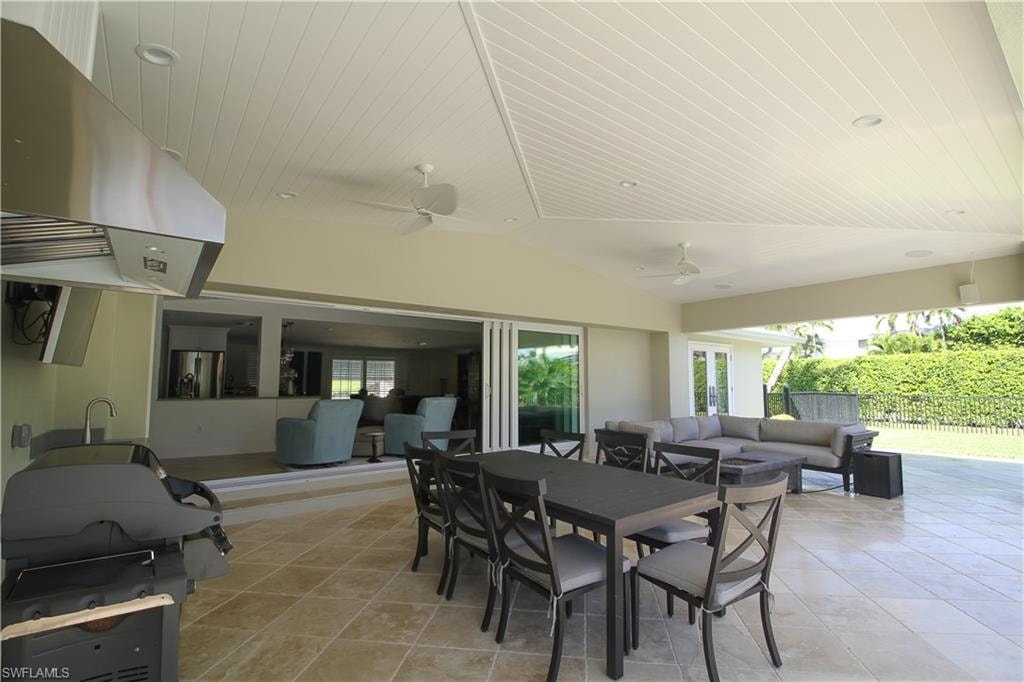 View of patio featuring an outdoor living space, outdoor dining space, area for grilling, and a ceiling fan