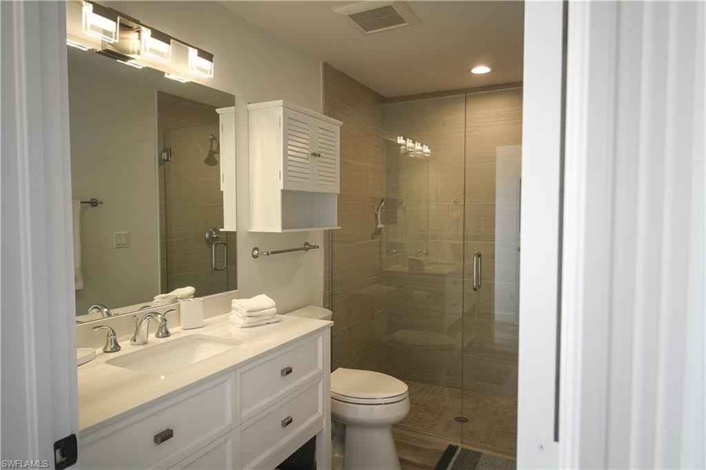 Bathroom with vanity and a stall shower