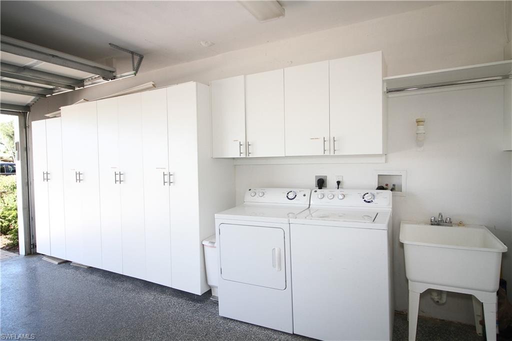 Laundry area with separate washer and dryer and cabinet space