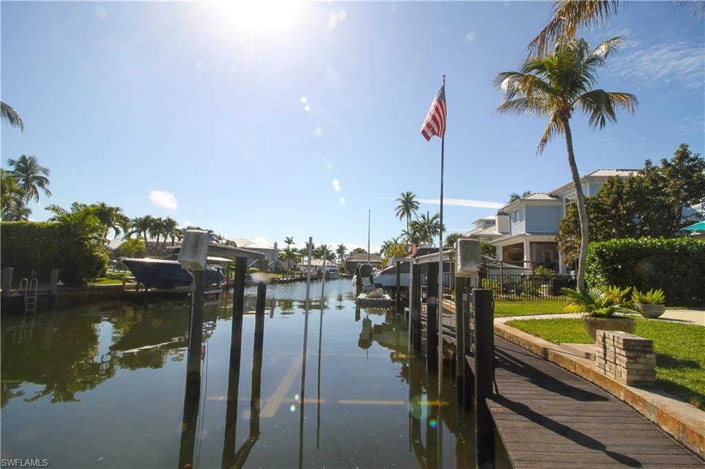 Dock area with boat lift and a water view