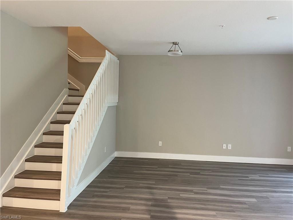 Staircase featuring wood finished floors and baseboards