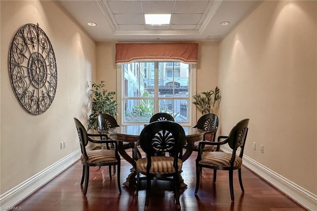 Dining space featuring dark wood-style flooring