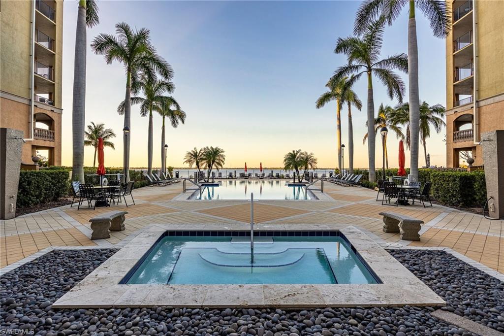 Community pool with a patio and a hot tub