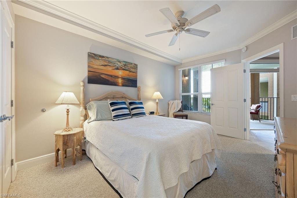 Bedroom featuring ornamental molding, light colored carpet, and a ceiling fan