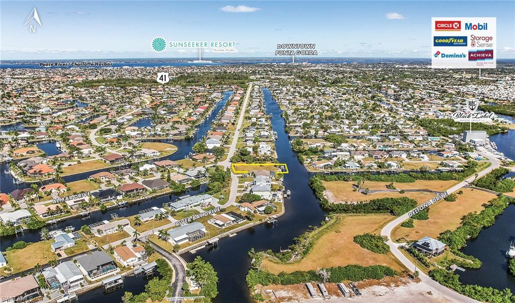Aerial view of property's location featuring nearby suburban area