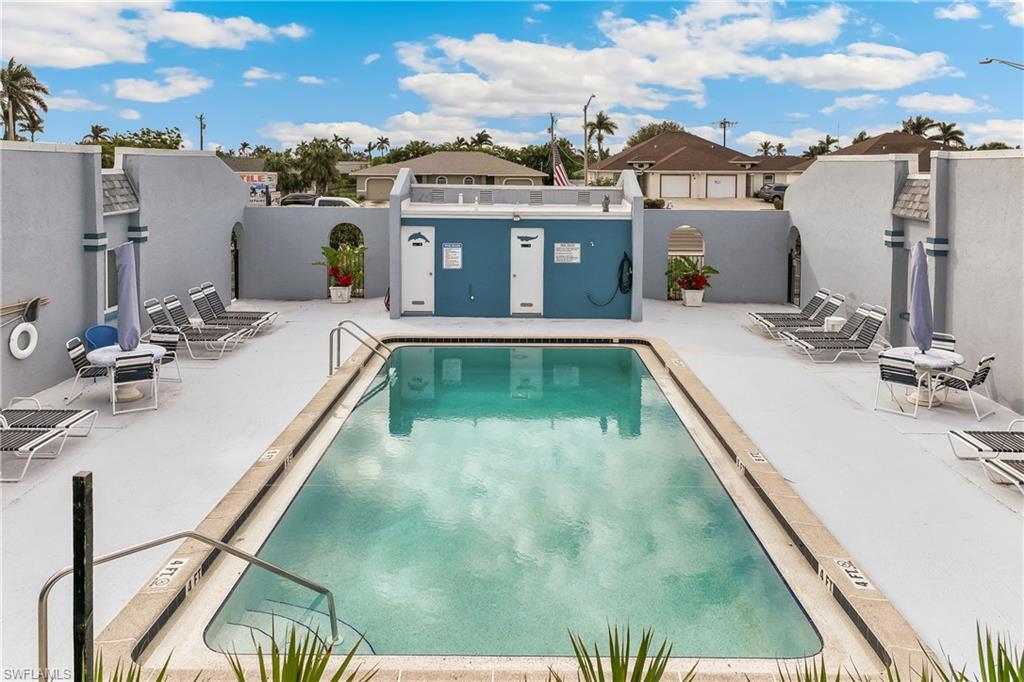 Community pool featuring a patio and a residential view