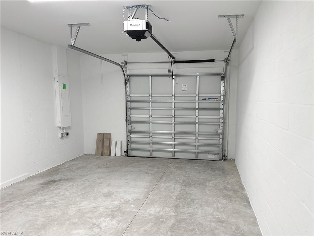 Garage with concrete block wall and a garage door opener