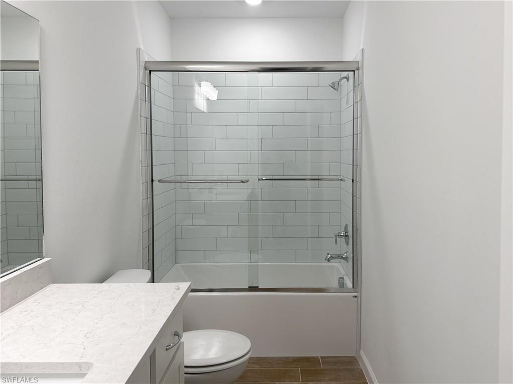 Bathroom with enclosed tub / shower combo and vanity