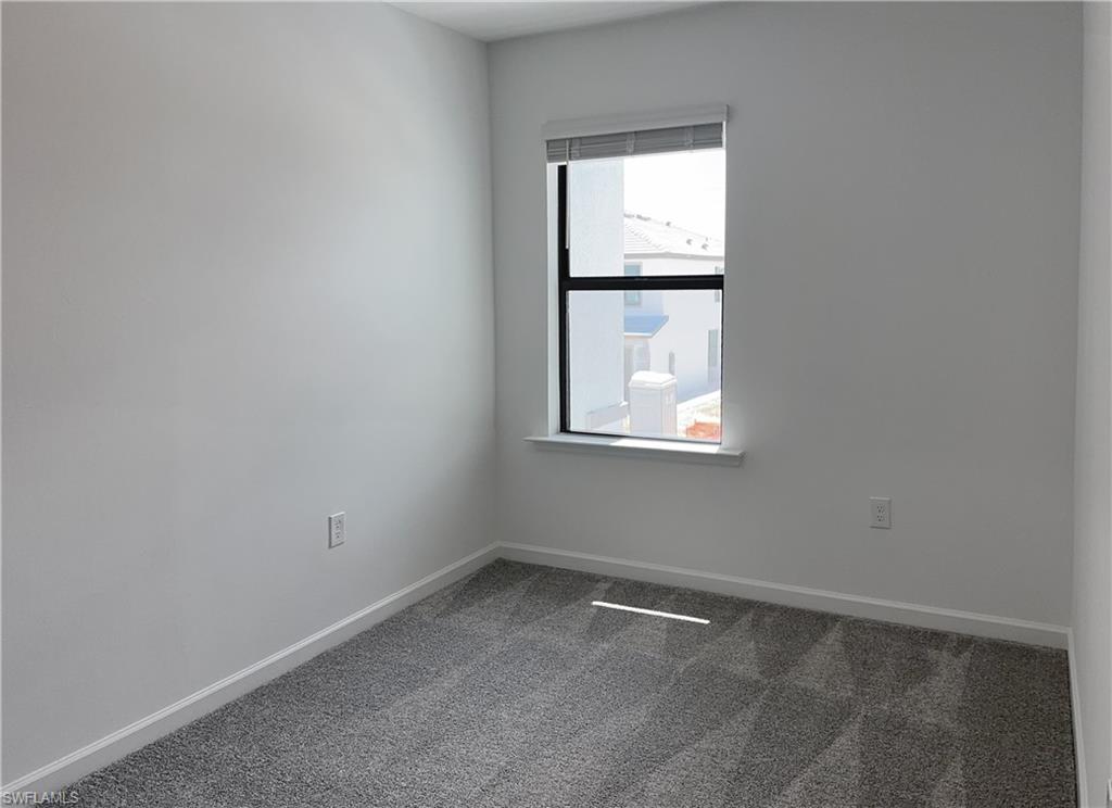 Unfurnished room with carpet flooring and baseboards