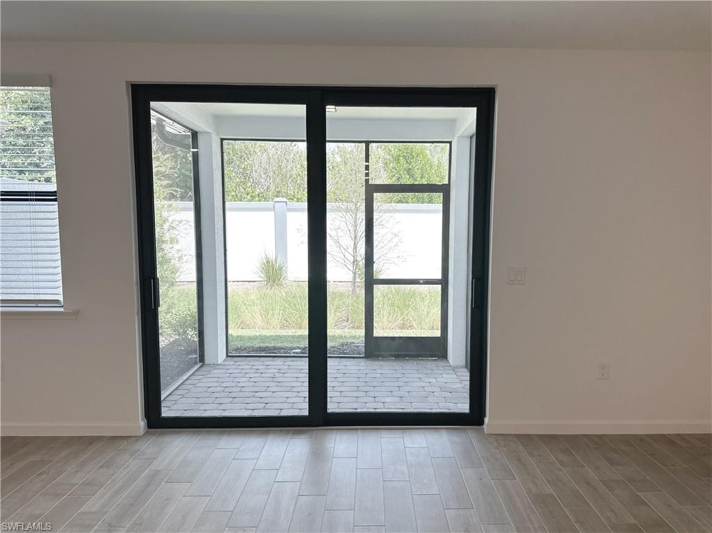 Entryway with plenty of natural light and screened in lanai