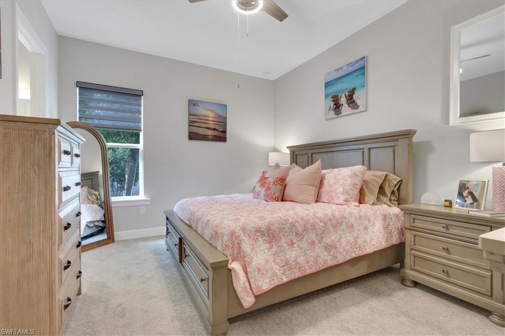 Bedroom featuring light colored carpet and a ceiling fan