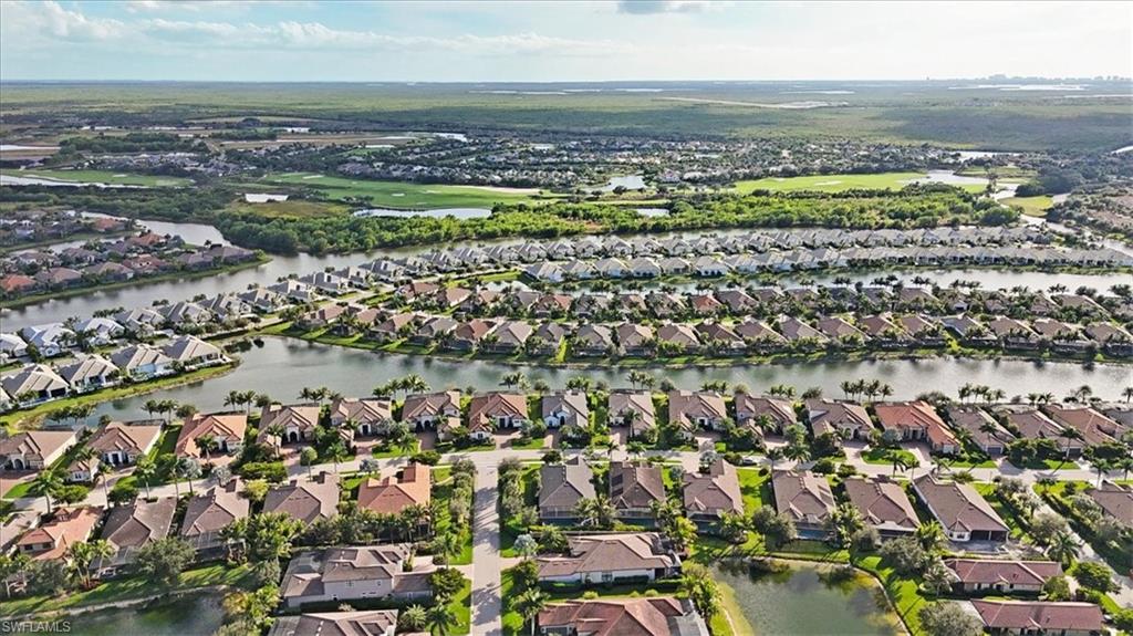 Aerial overview of property's location with a nearby body of water and nearby suburban area