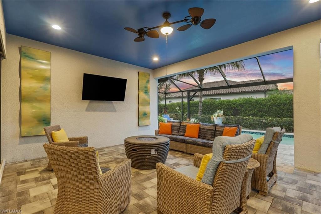 View of patio / terrace with an outdoor living space, an outdoor pool, glass enclosure, ceiling fan, and a sunroom