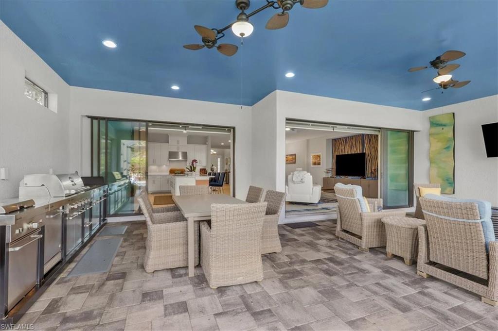 View of patio featuring a ceiling fan, area for grilling, and outdoor dining area