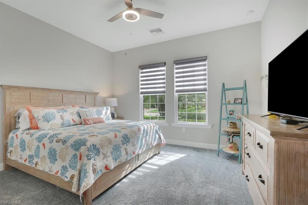 Bedroom featuring light colored carpet and ceiling fan