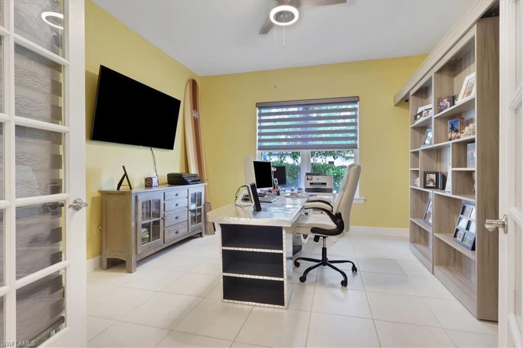 Office featuring a ceiling fan and light tile patterned floors