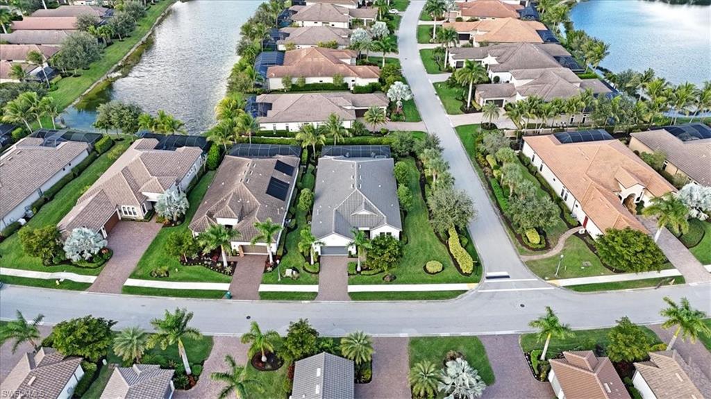 Aerial view of property's location featuring a large body of water and nearby suburban area