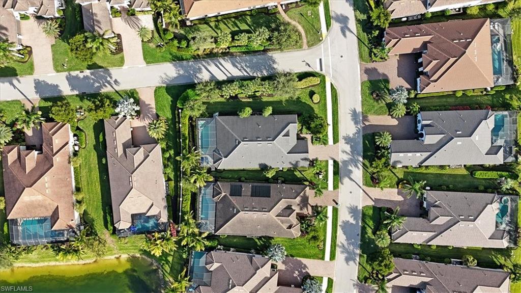 Aerial view of property and surrounding area with nearby suburban area