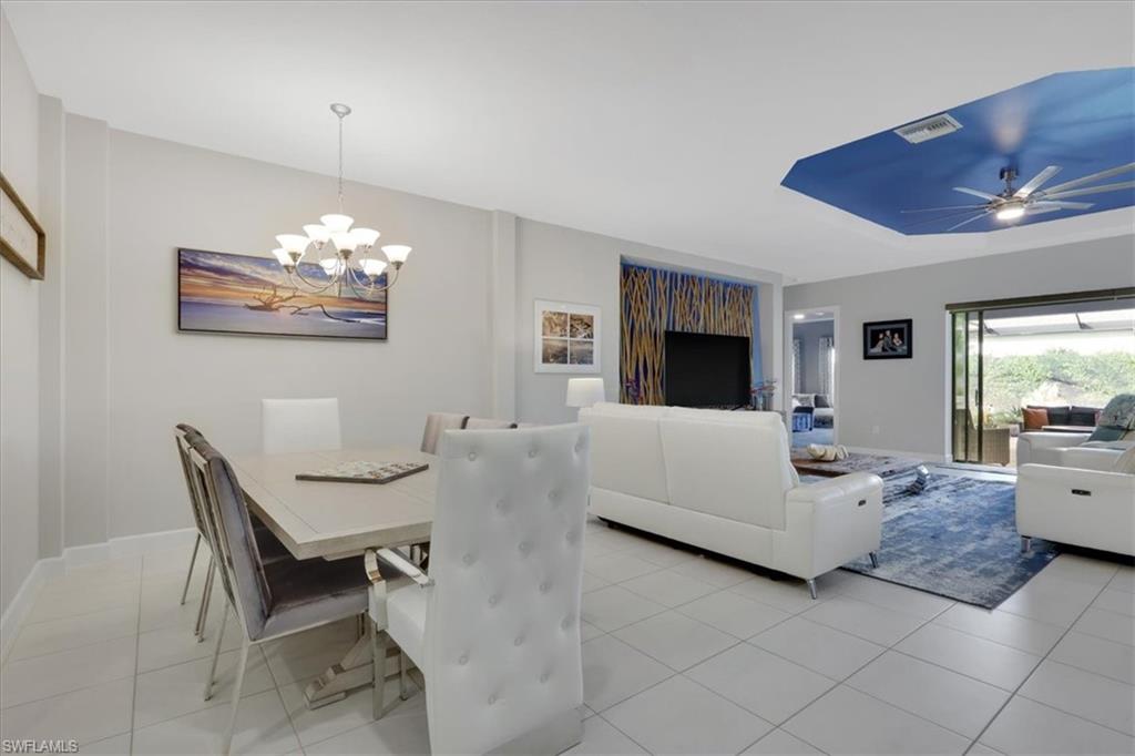 Dining area featuring light tile patterned floors and a chandelier