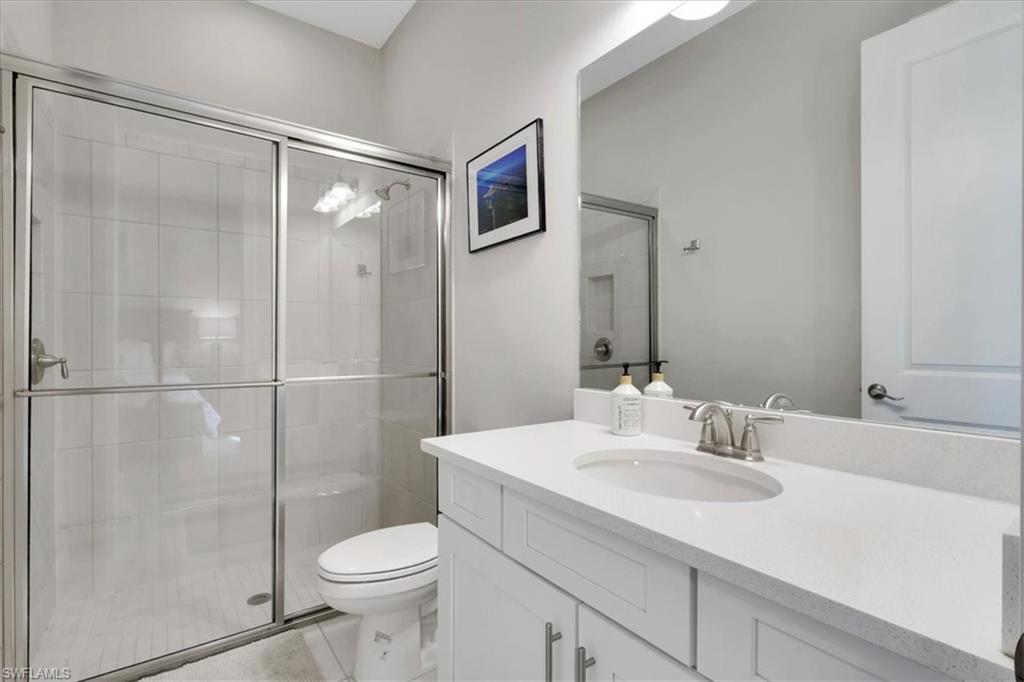Full bathroom with a stall shower and vanity