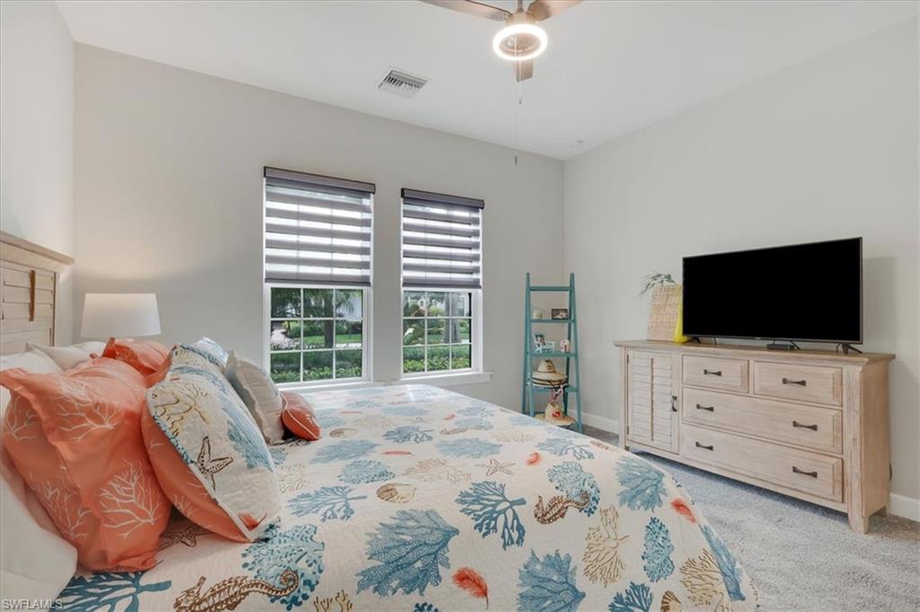 Bedroom featuring light carpet and a ceiling fan