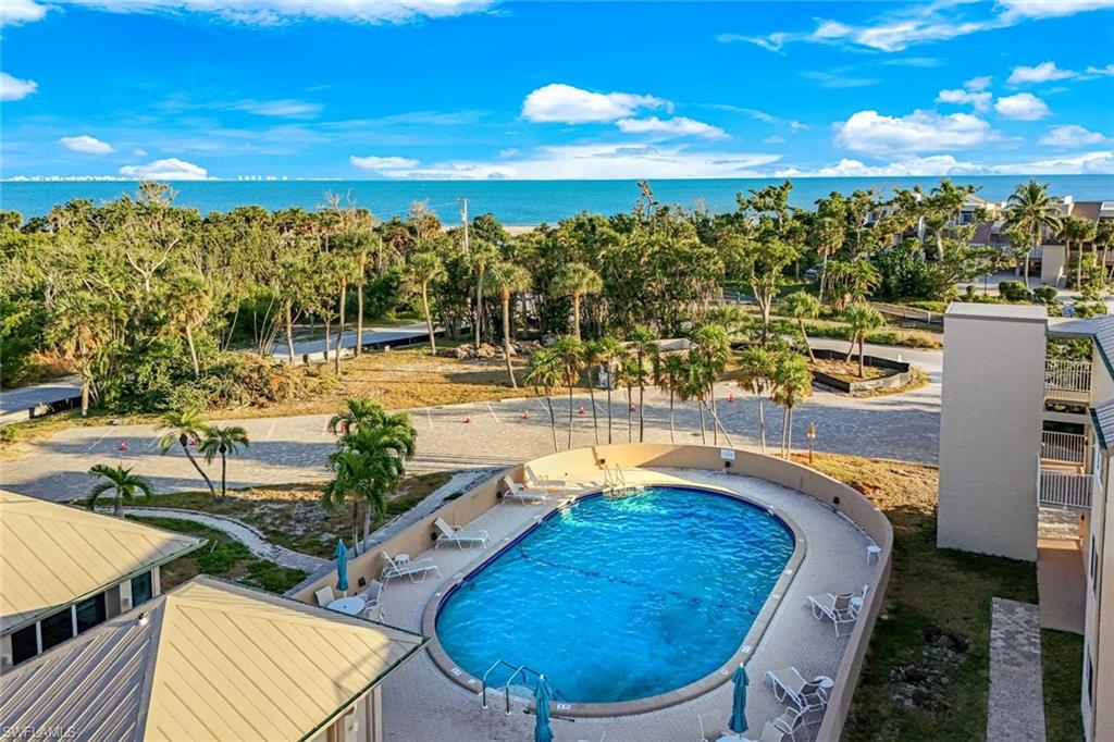 Community pool featuring a water view and a patio