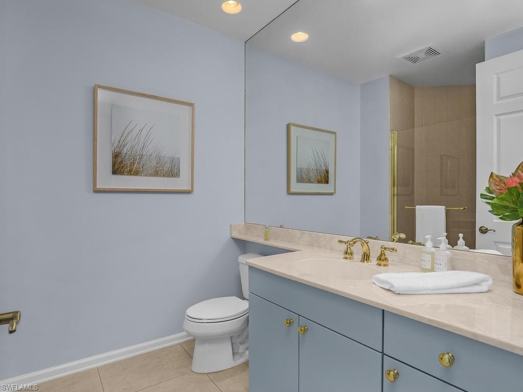 Full bath alongside den should it be reimagined as a BR.  bedroom.  Actually staged as game room; virtually staged as BR.