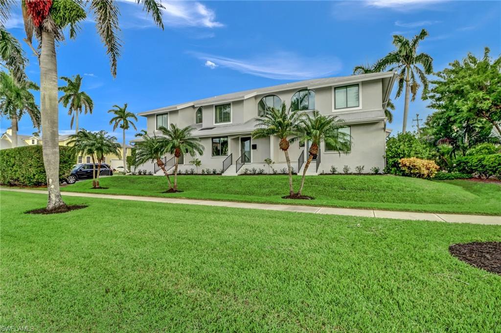 View of front of property featuring stucco siding and a front yard