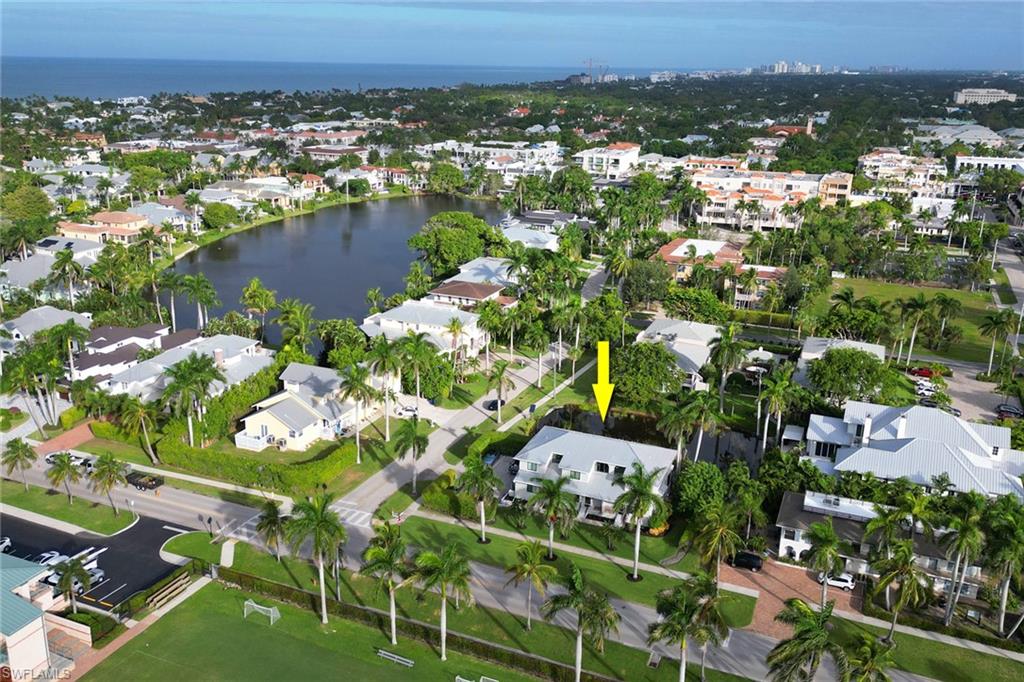 Aerial view of property and surrounding area with a large body of water and nearby suburban area