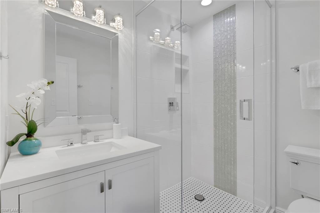 Full bathroom with a shower stall and vanity