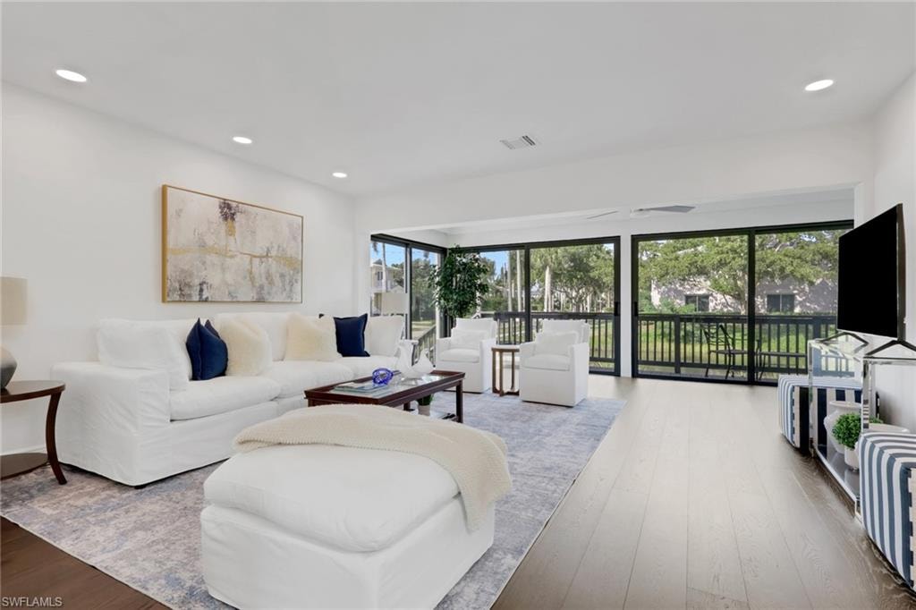 Living area featuring hardwood / wood-style floors and recessed lighting