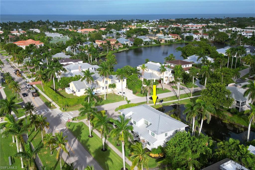 Aerial view of residential area featuring a nearby body of water