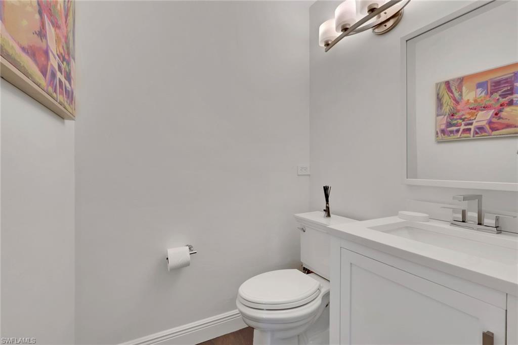 Bathroom featuring vanity and dark wood-style flooring